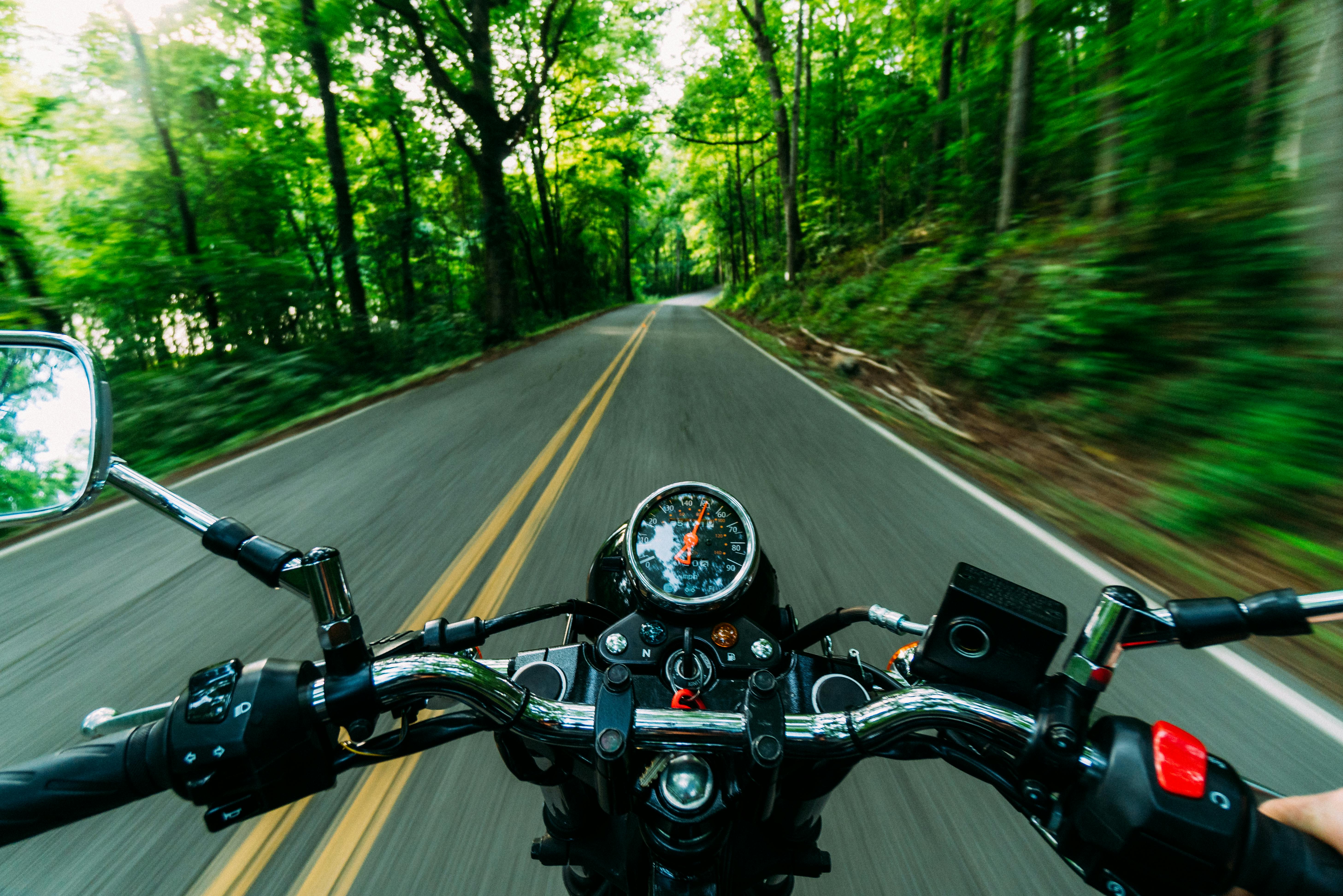 First-person view from motorbike handlebars on open road