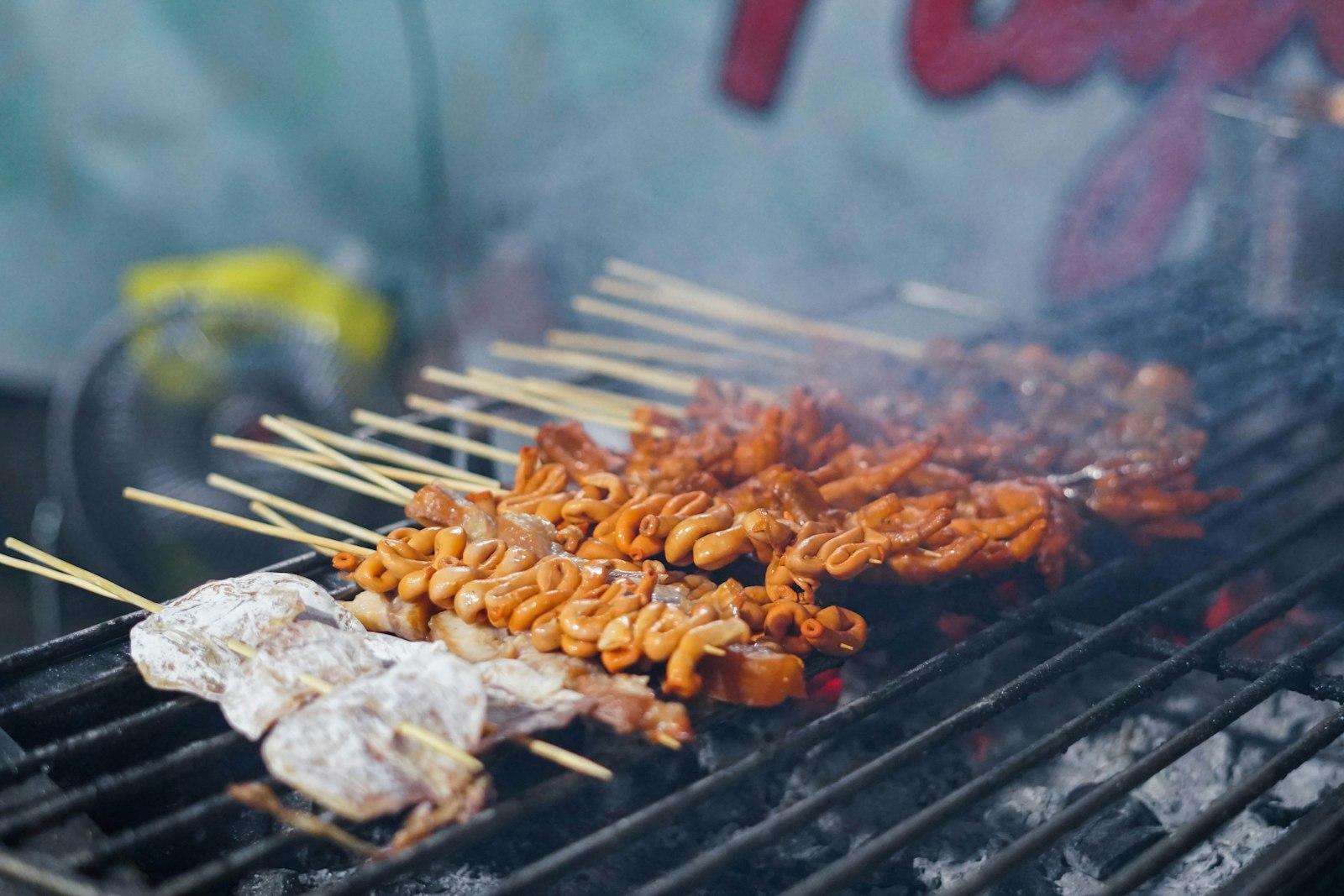 Grilled Filipino street food on a black grill
