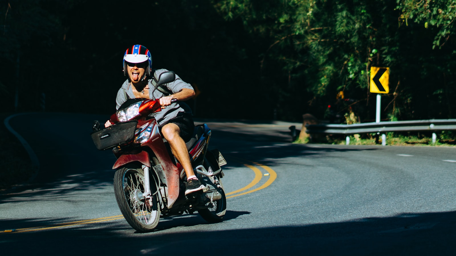 Motorbike rider on a curved road in northern Thailand