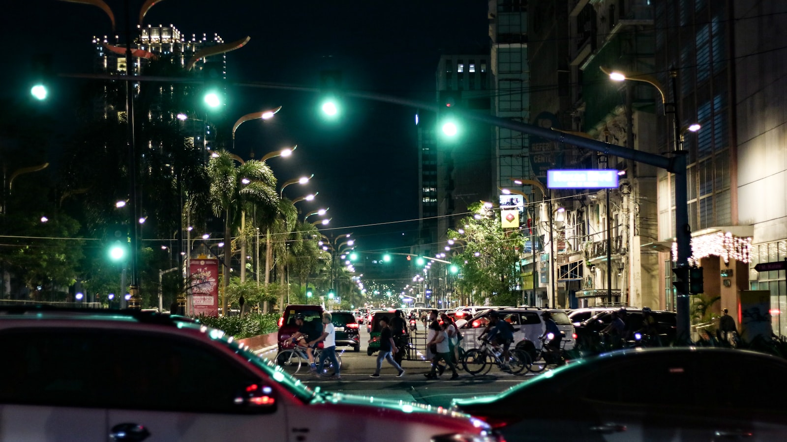 Busy Manila street at night with neon and pedestrians