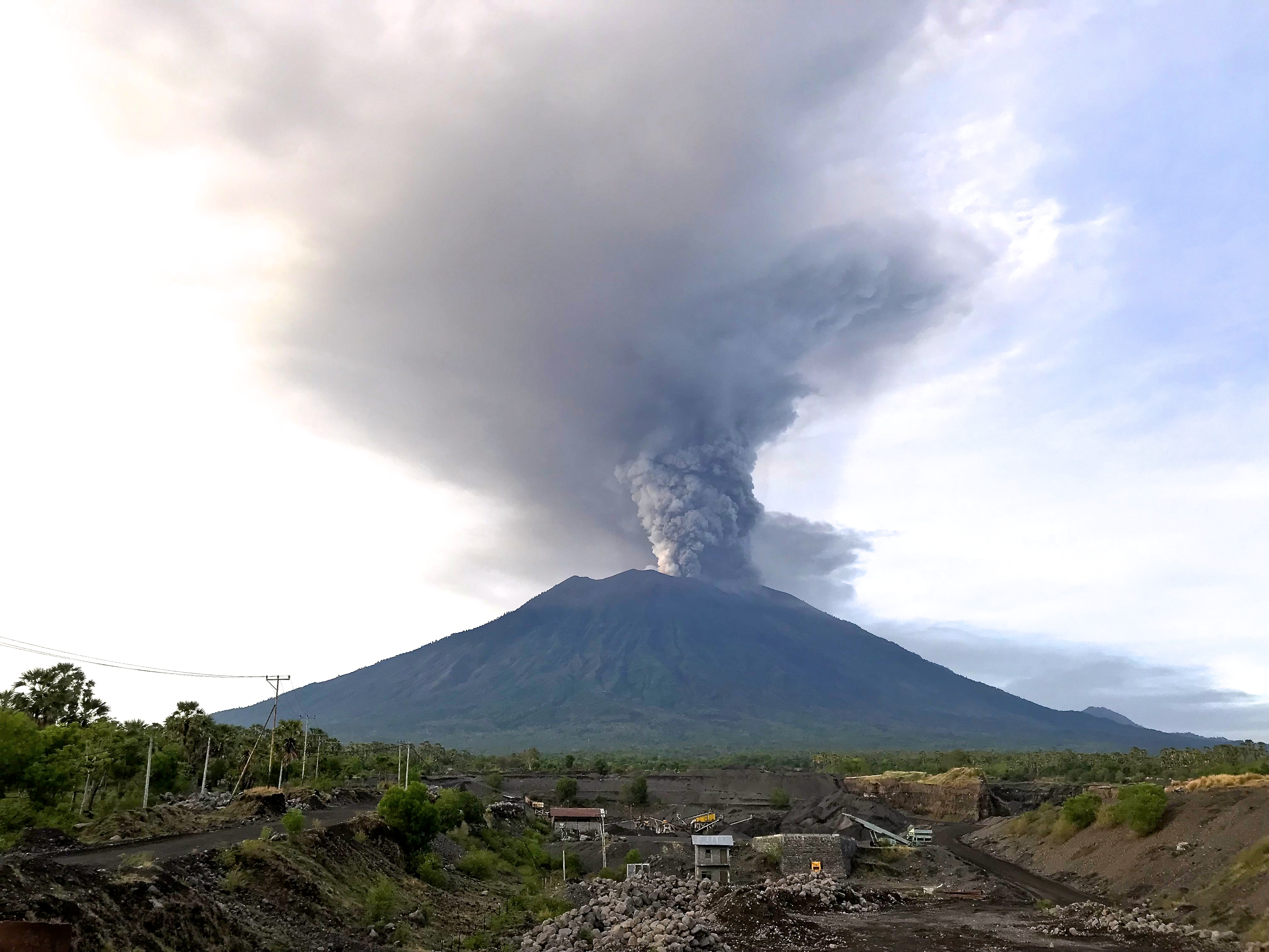Mount Agung erupting with a tall grey ash plume