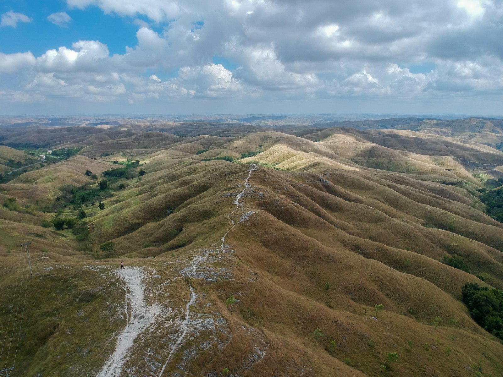 Aerial view of Sumba's undulating ridges and coast