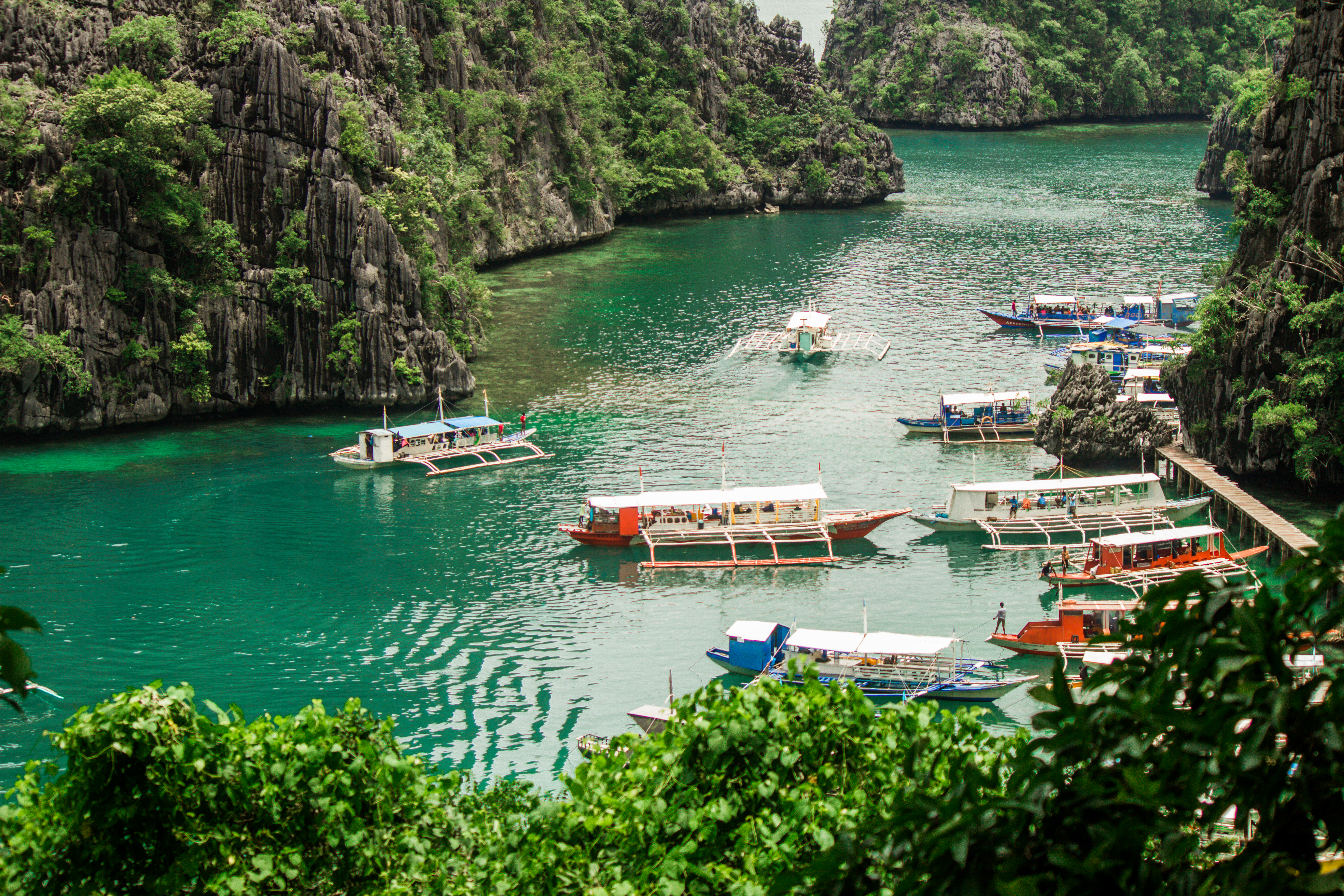 Kayangan Lake from the upper viewpoint, teal water held inside vertical karst, Coron Island, Palawan