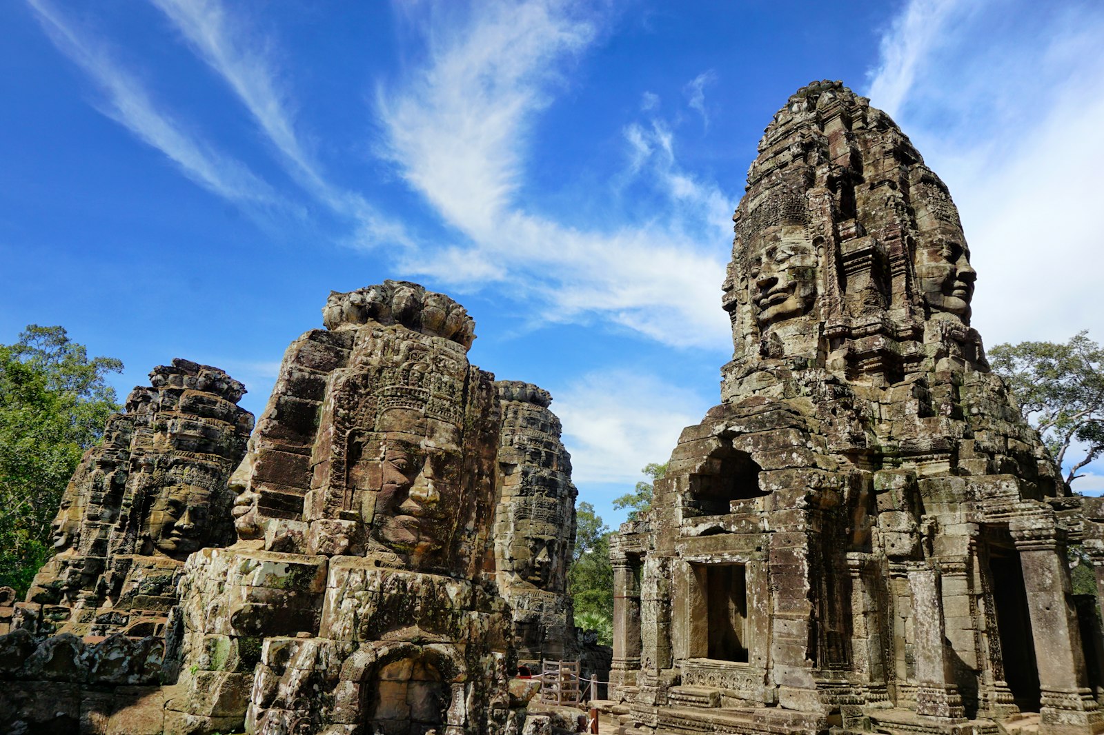 Bayon stone faces under hard blue sky