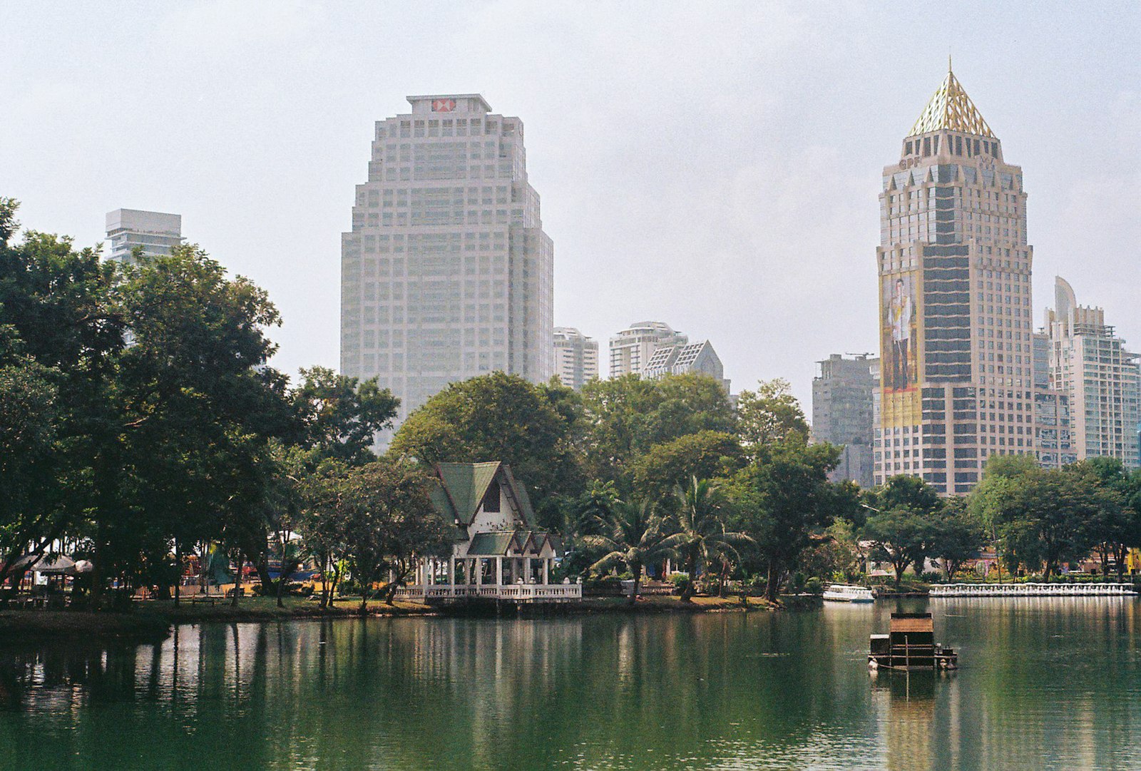 Lumphini Park lake with Bangkok skyline behind