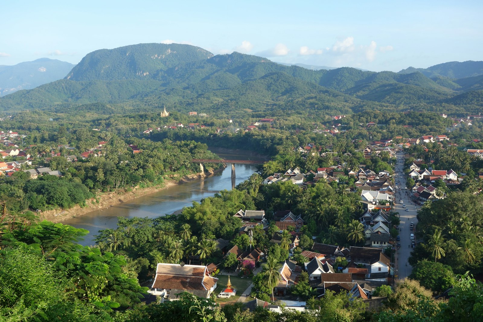 Quiet river running through a lush, forested valley near Luang Prabang, Laos