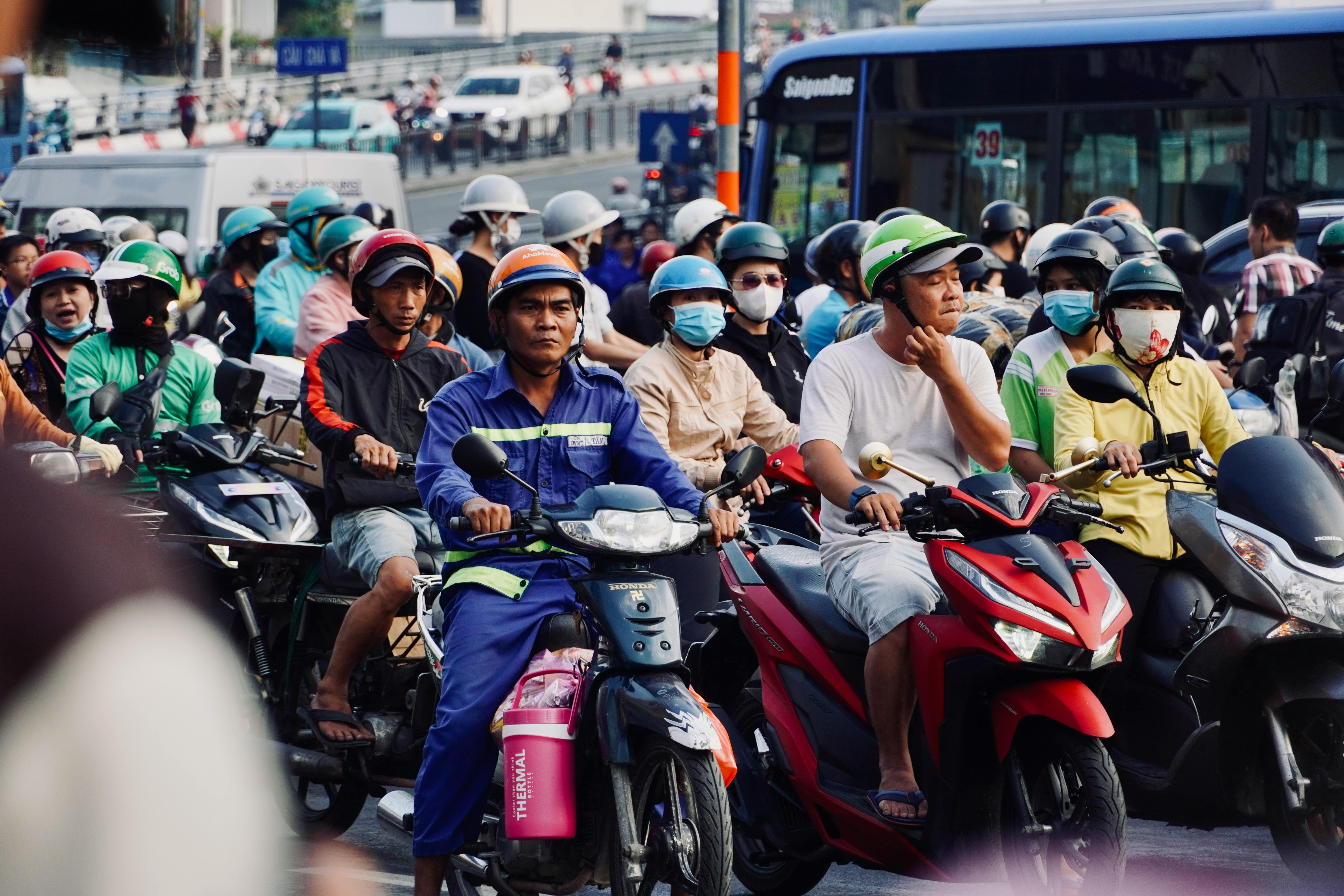 Dense motorbike traffic on a Southeast Asian city street
