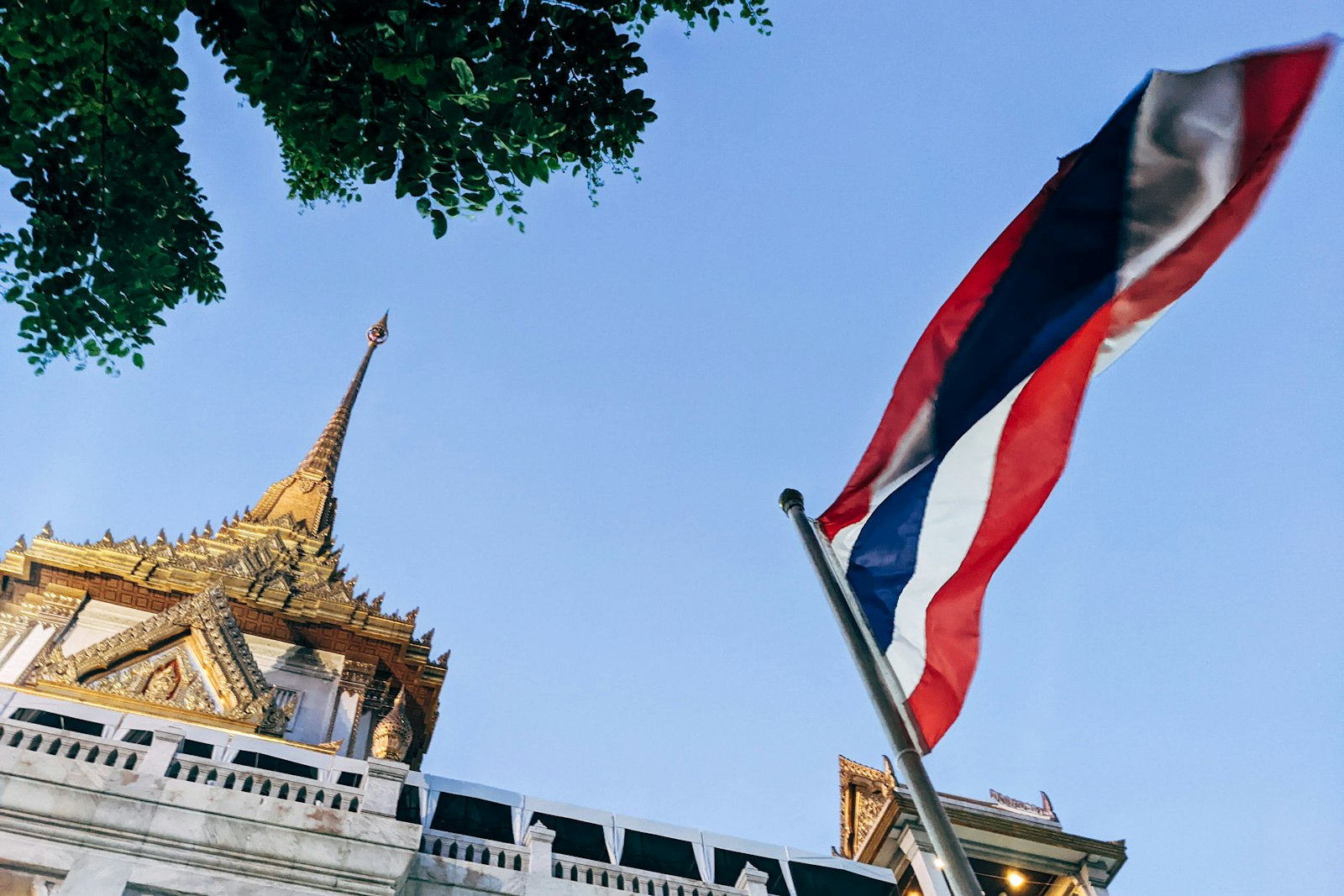 Thai national flag flying in front of a building