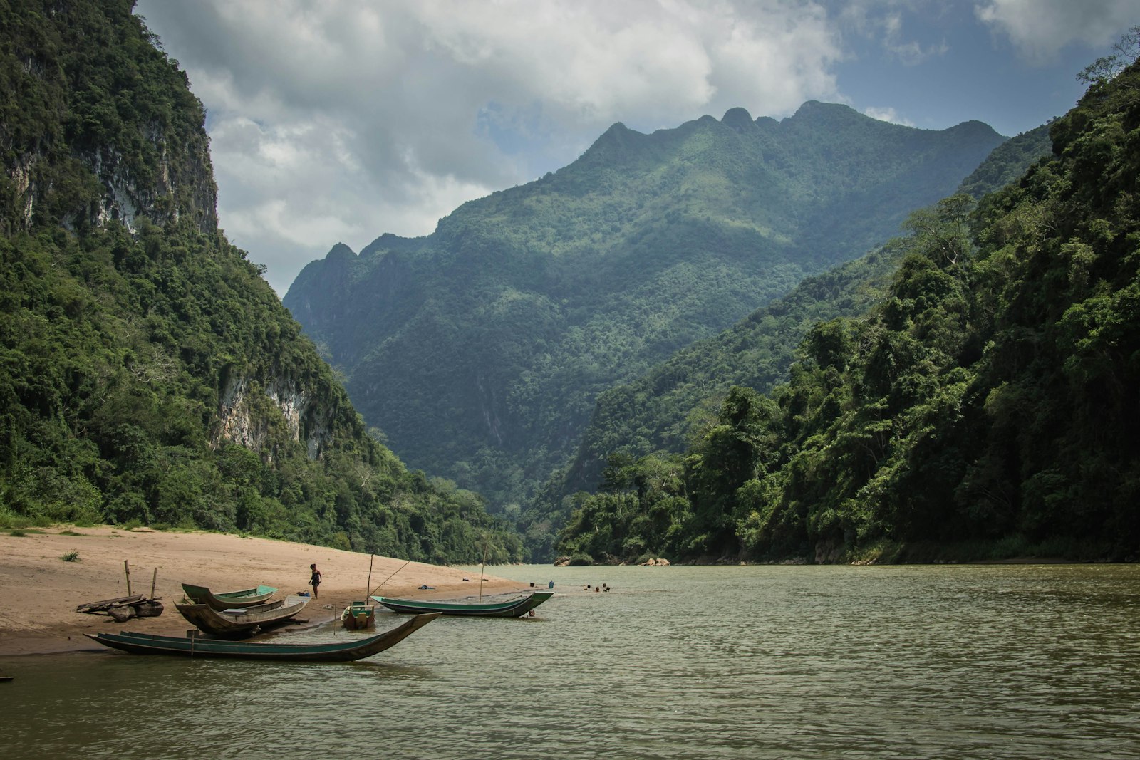 Two boats on a Lao river at dusk