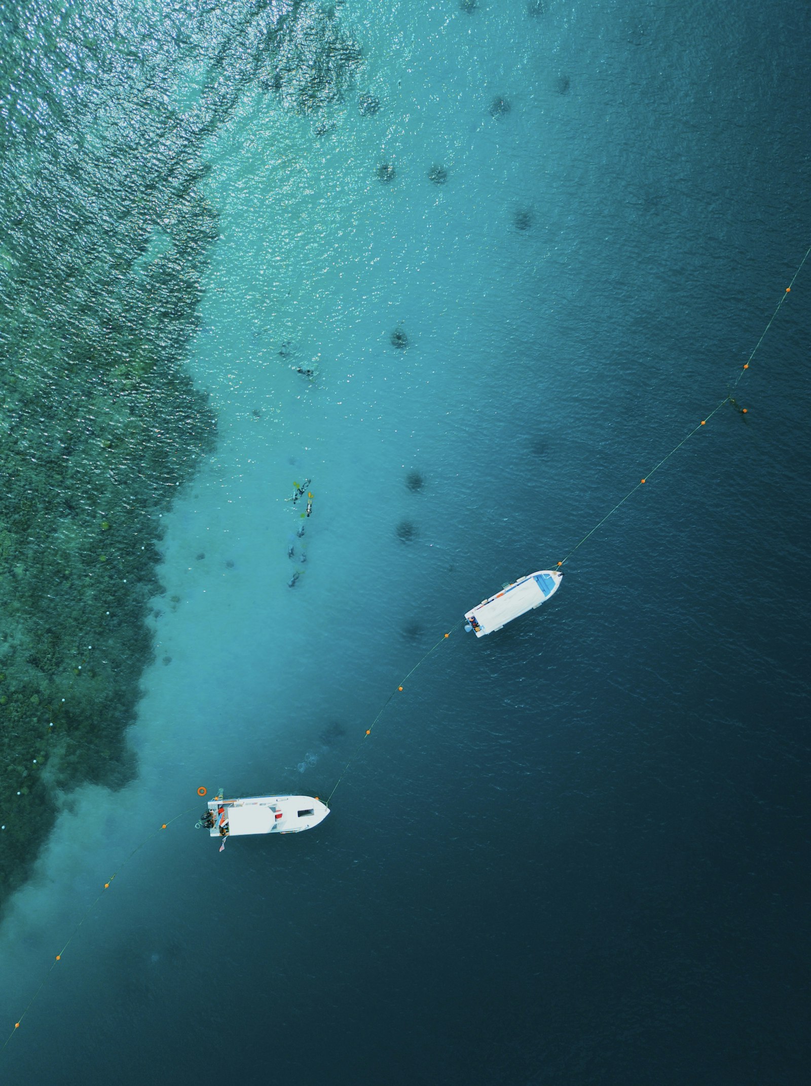 Aerial of two dive boats over a reef
