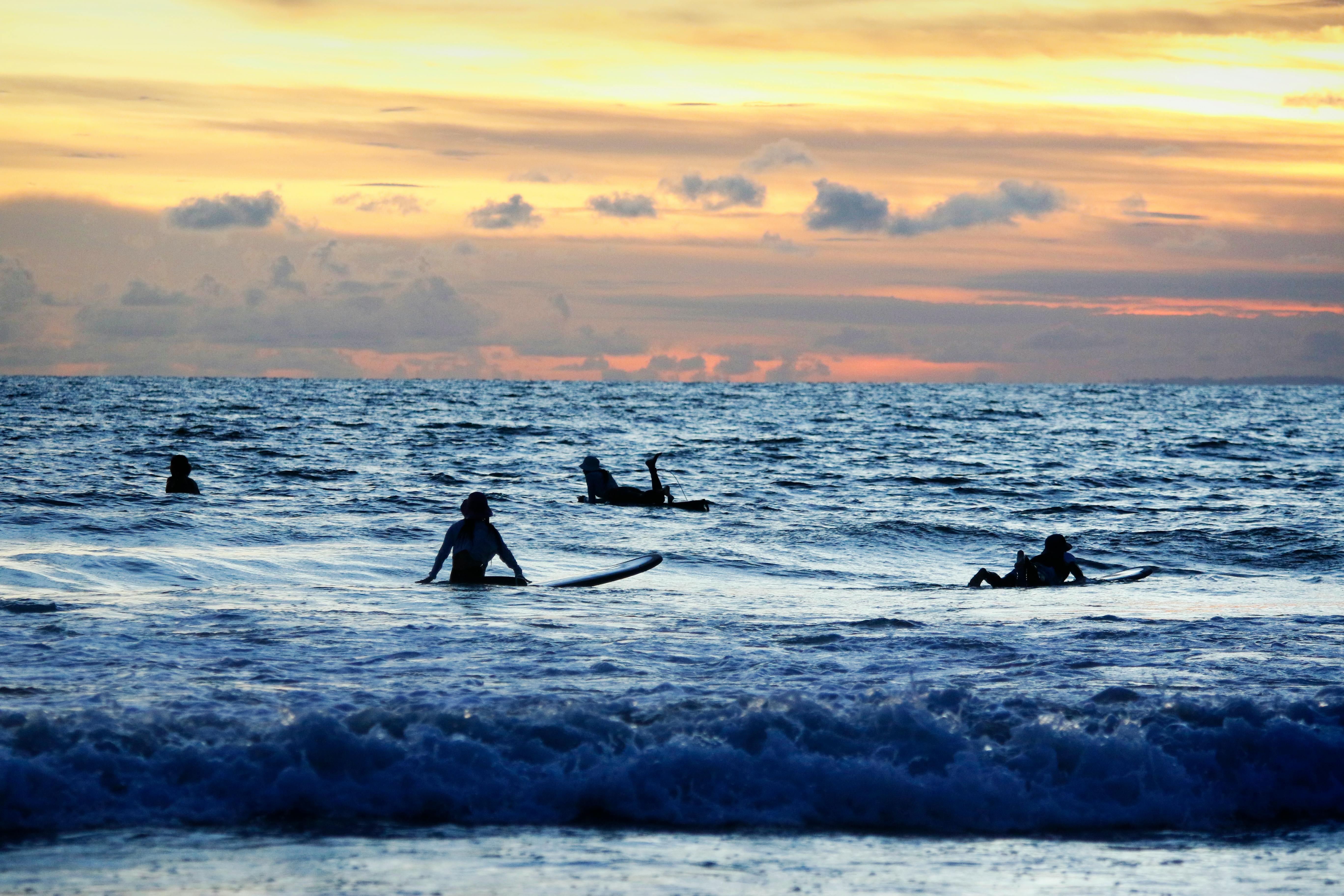 Surfers at Kuta Beach sunset, Bali