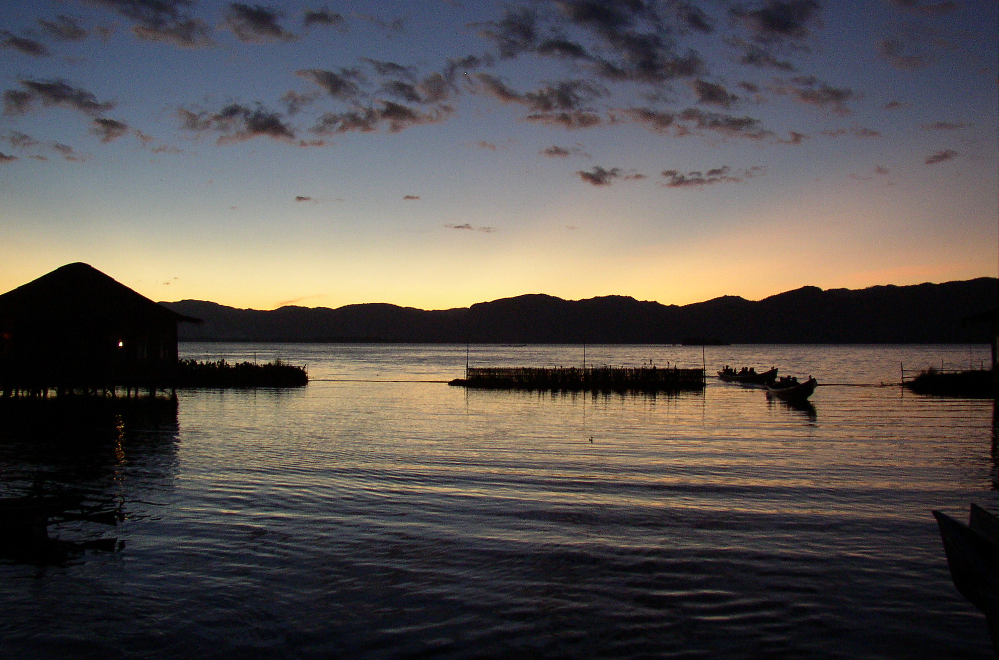 Inle Lake at evening with stilt houses and still water