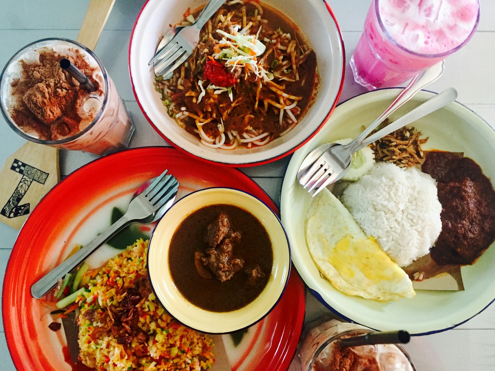 Plates of Malaysian food on a table