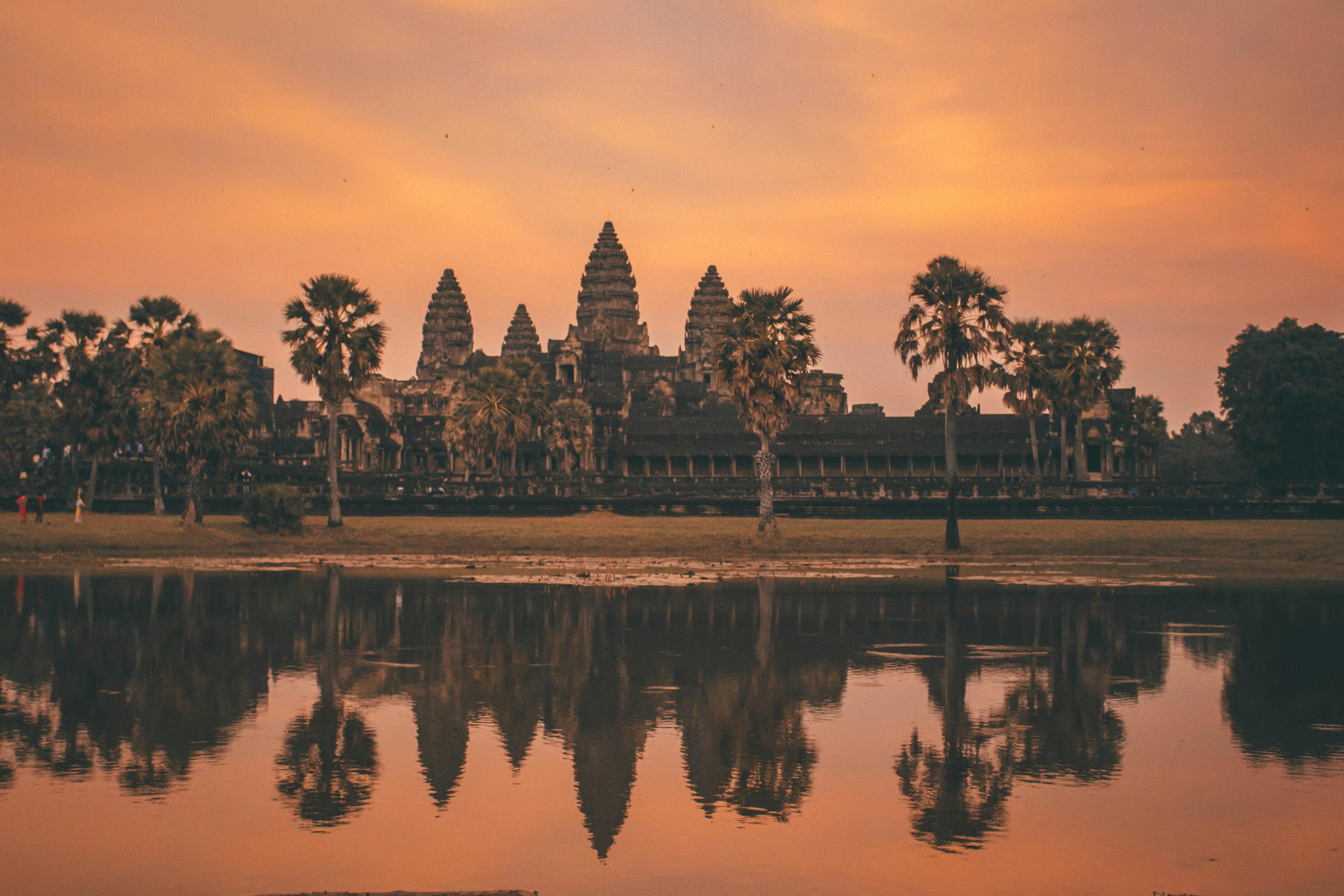 Angkor Wat temple reflected in water at sunrise