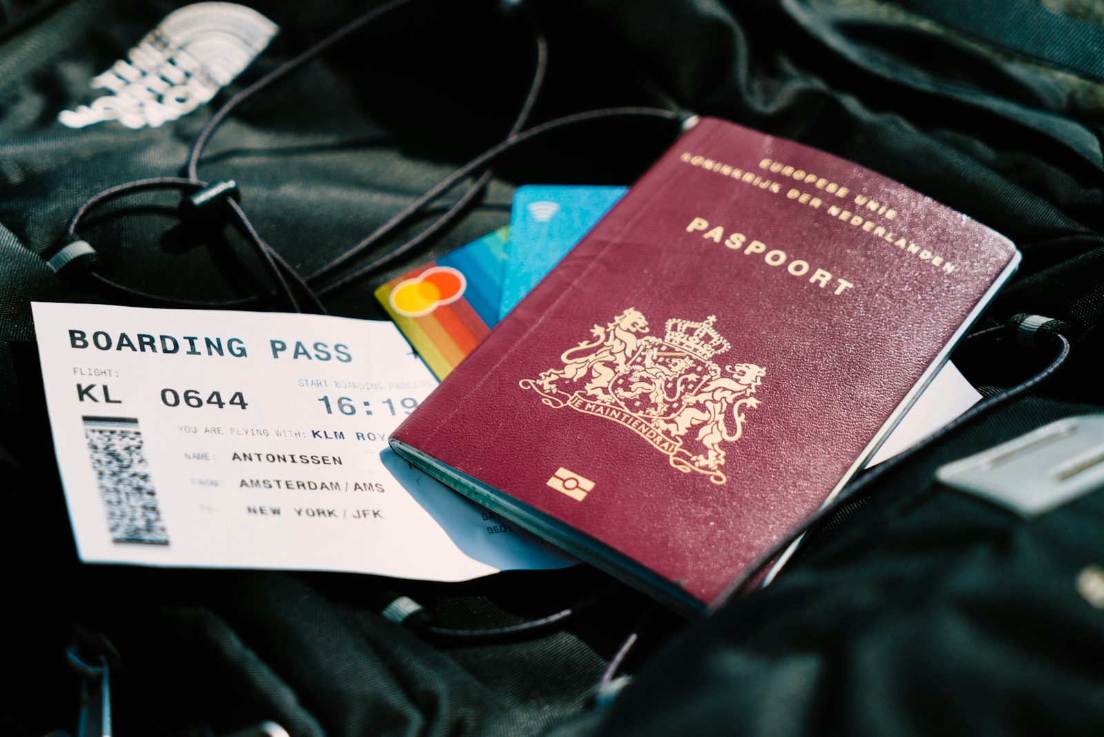 Passport and boarding pass resting on a travel bag