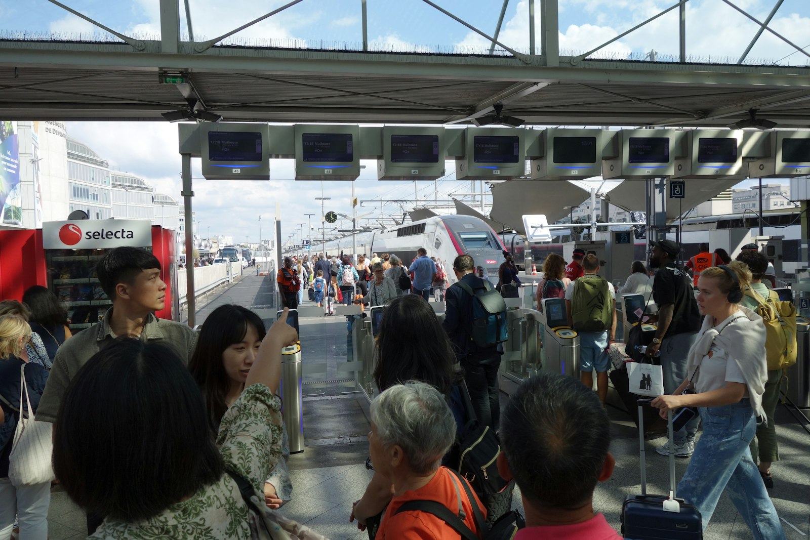 Travellers waiting in a busy airport terminal