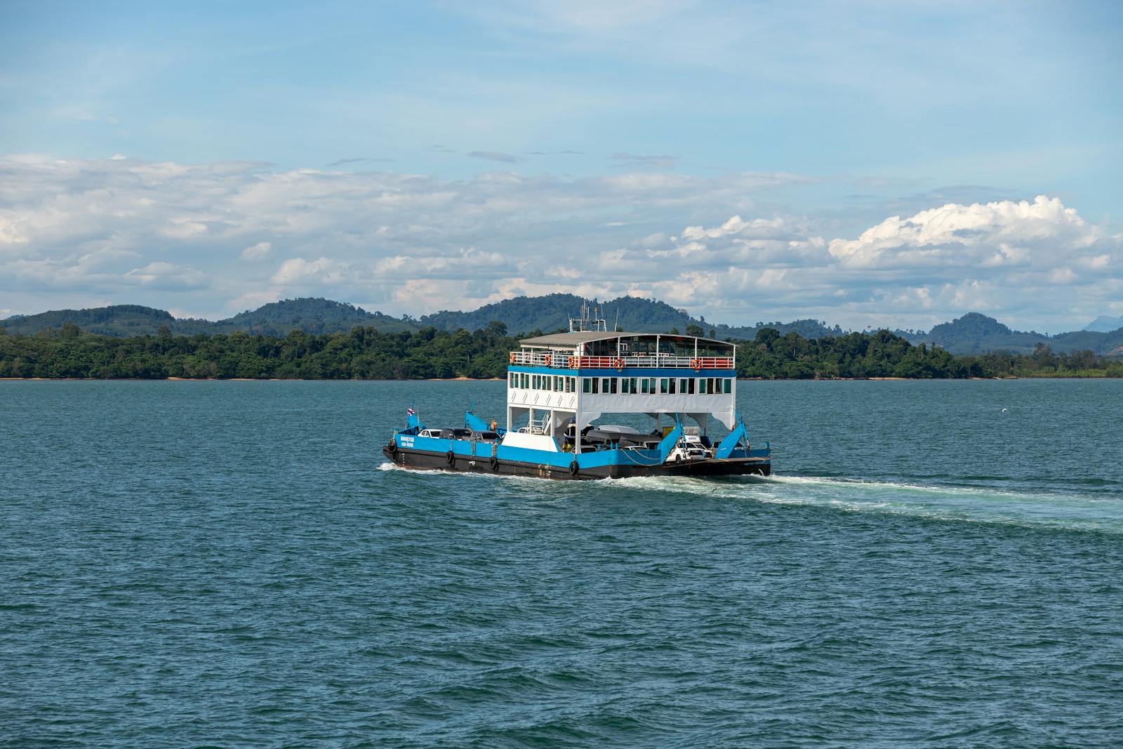 Passenger ferry crossing tropical waters near islands