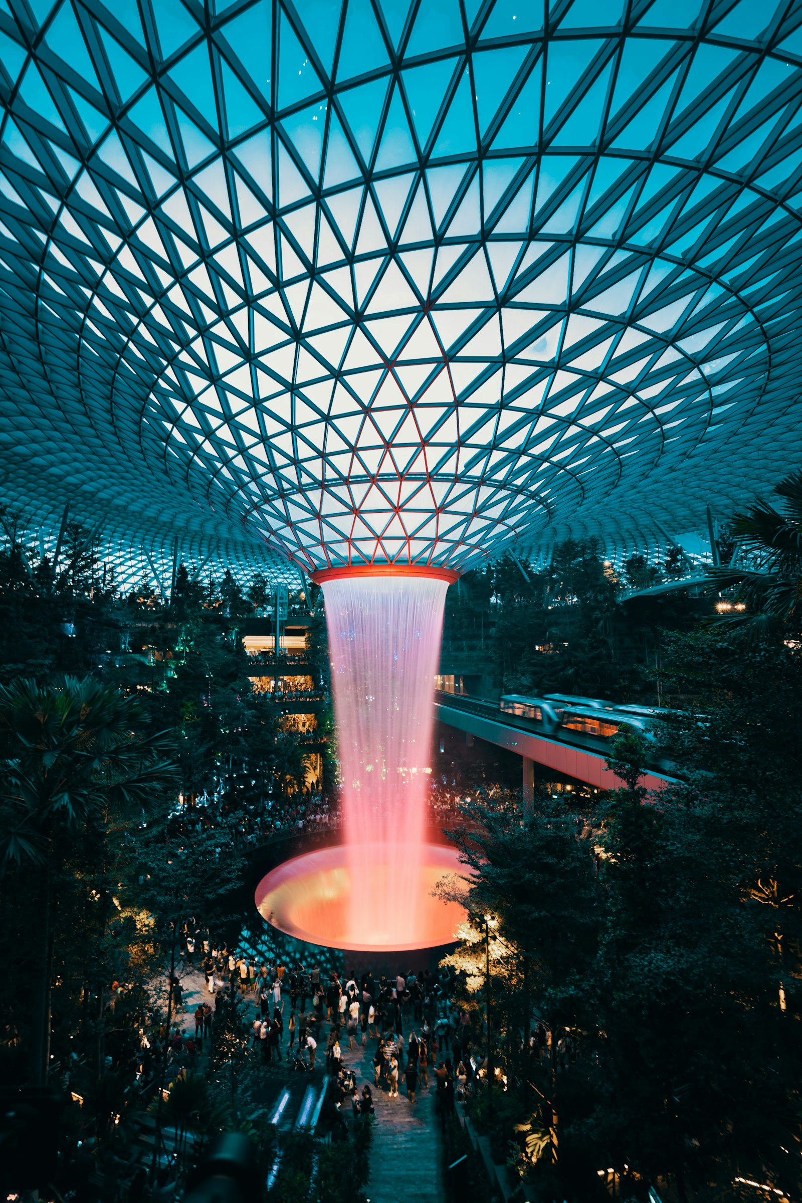 The Rain Vortex indoor waterfall at Jewel Changi Airport surrounded by visitors