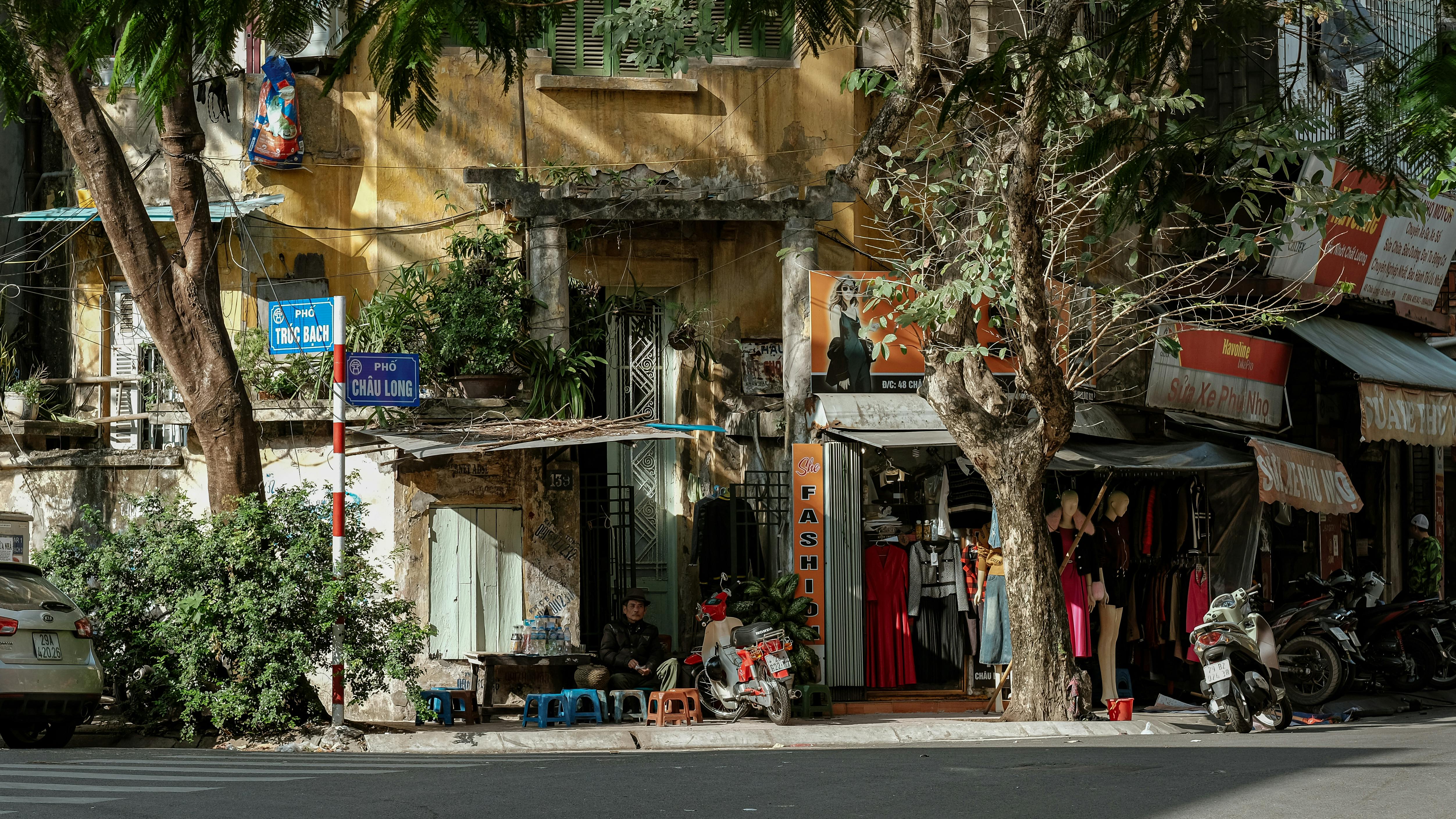 Hanoi street with motorbikes, shops and pedestrians