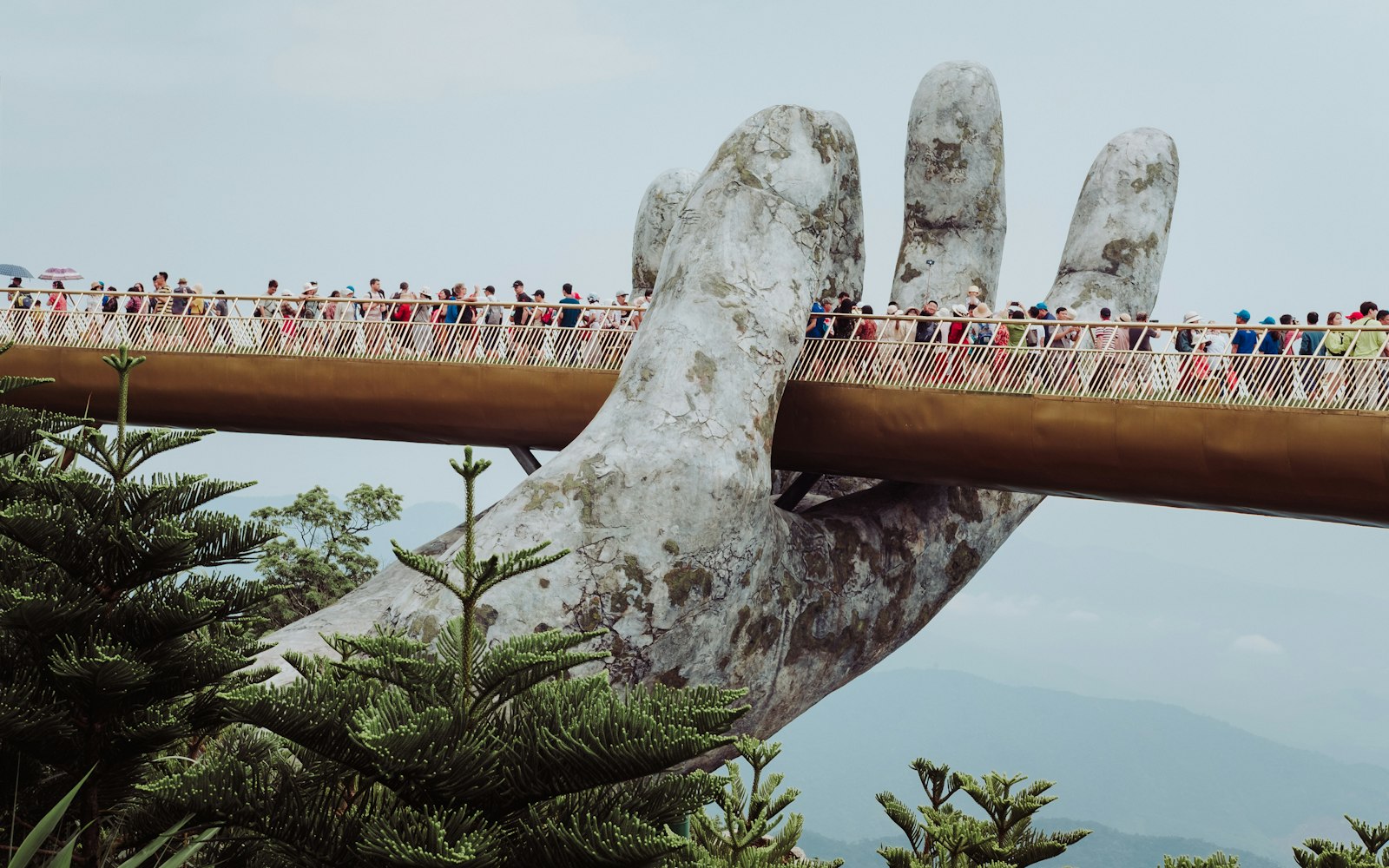 Crowds of visitors on a hilltop pedestrian bridge