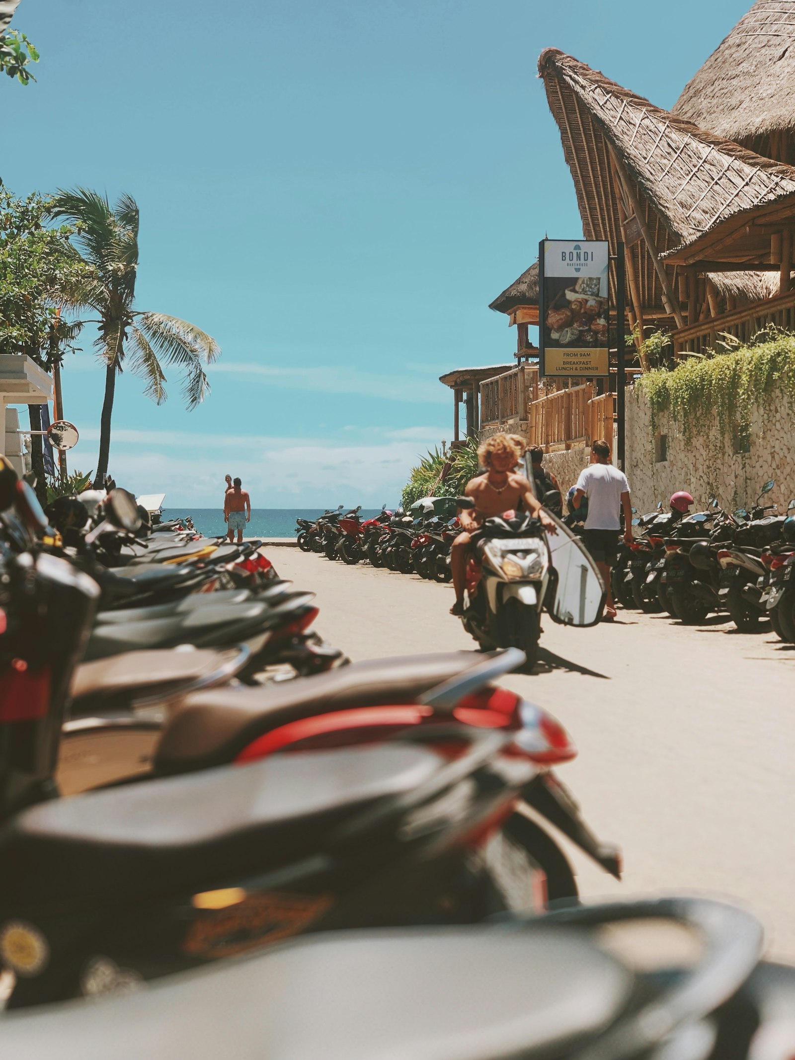 Scooters parked near a Bali beach