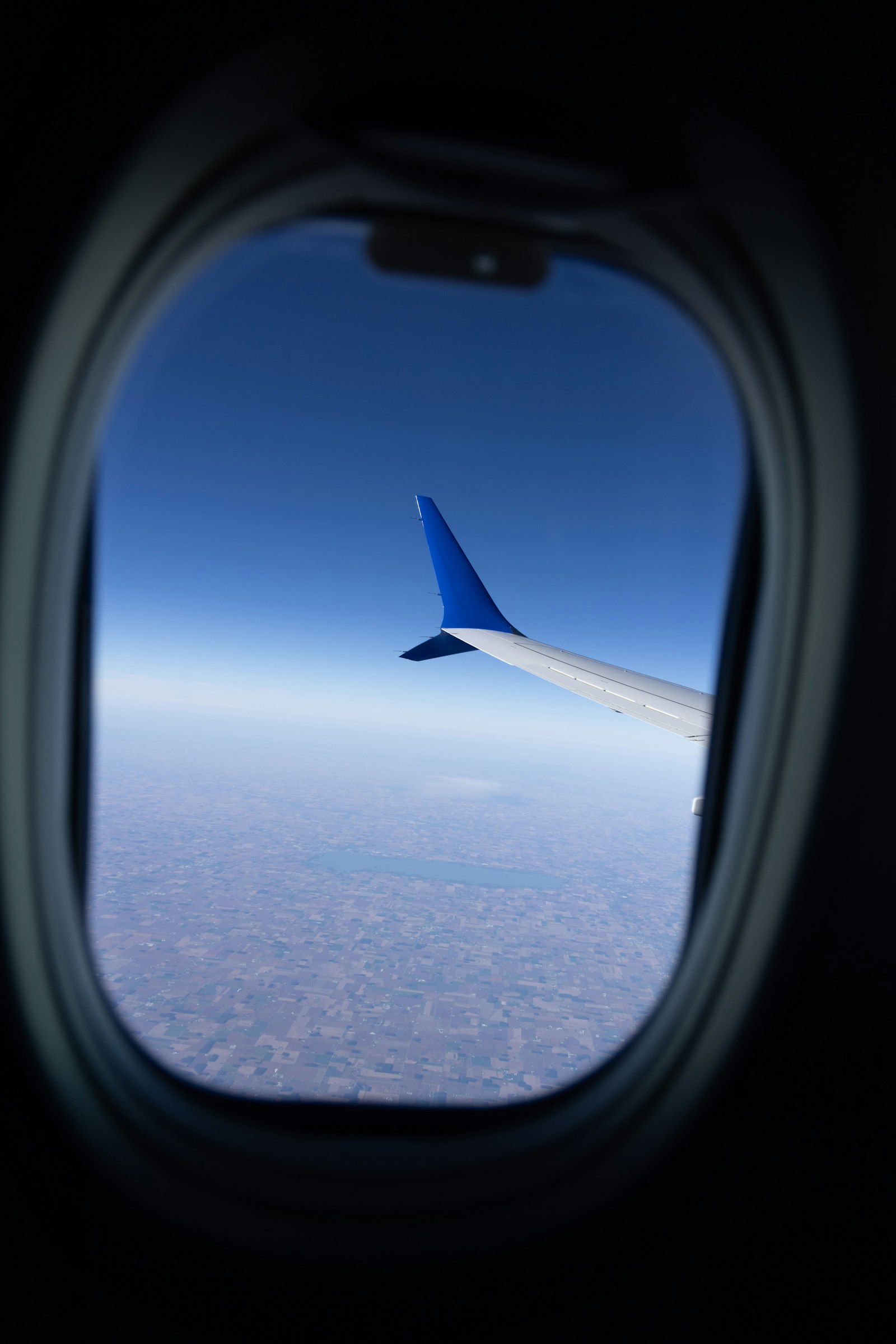 Airplane wing above the clouds from a window
