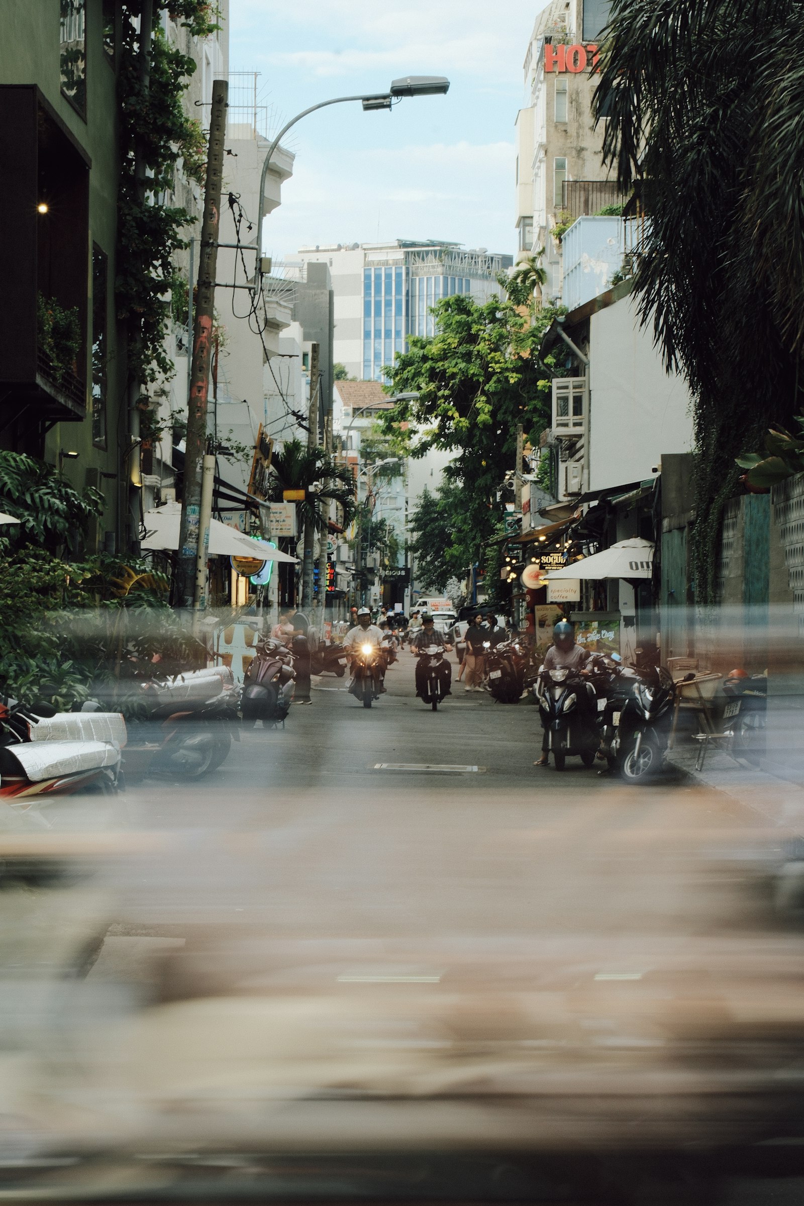 Motorbikes moving down a busy city street
