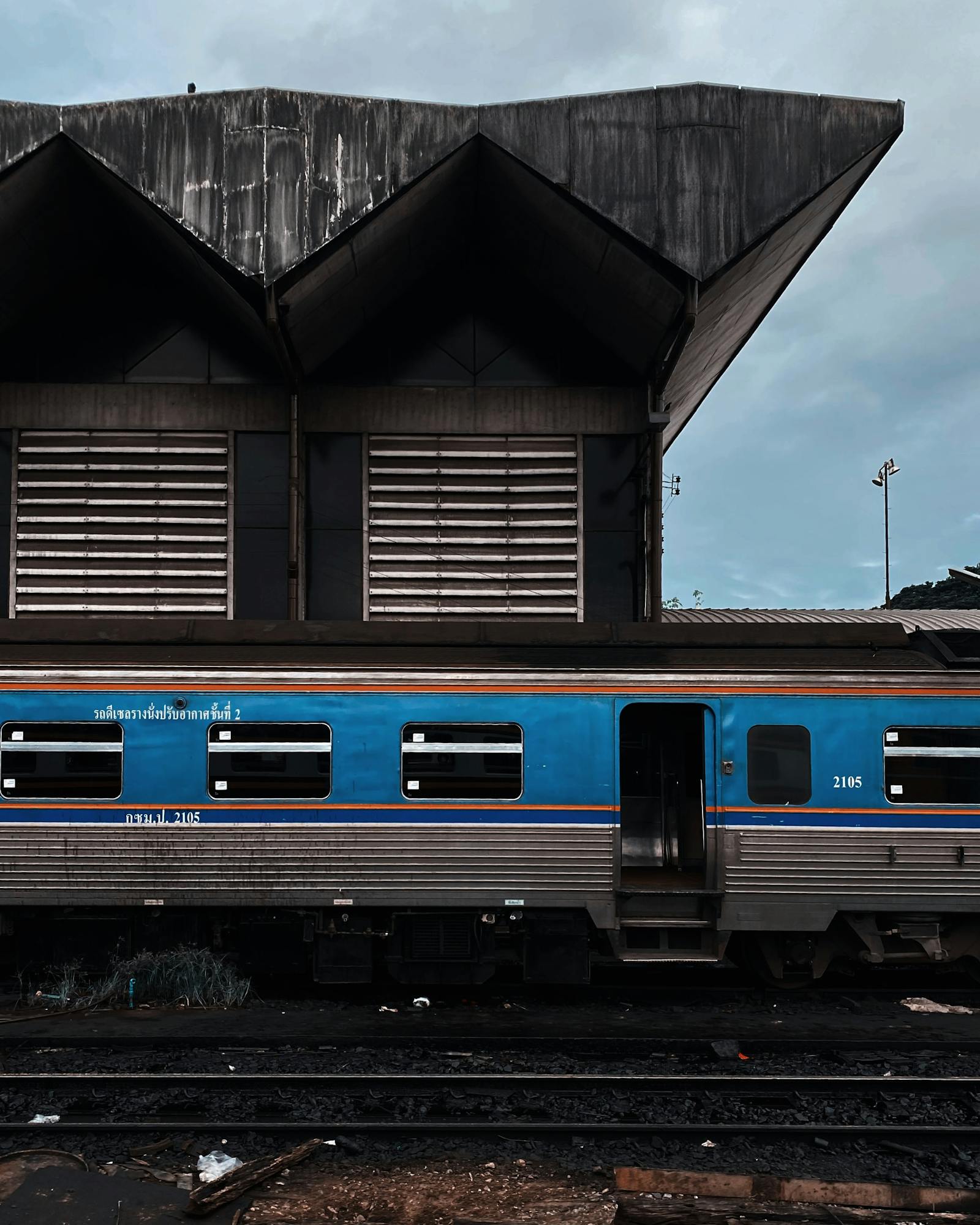 Blue Thai passenger train at a railway station