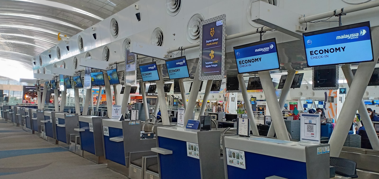 Row of electronic check-in counters at airport