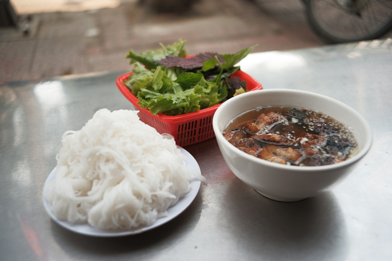 Vietnamese bun cha with noodles herbs and sauce