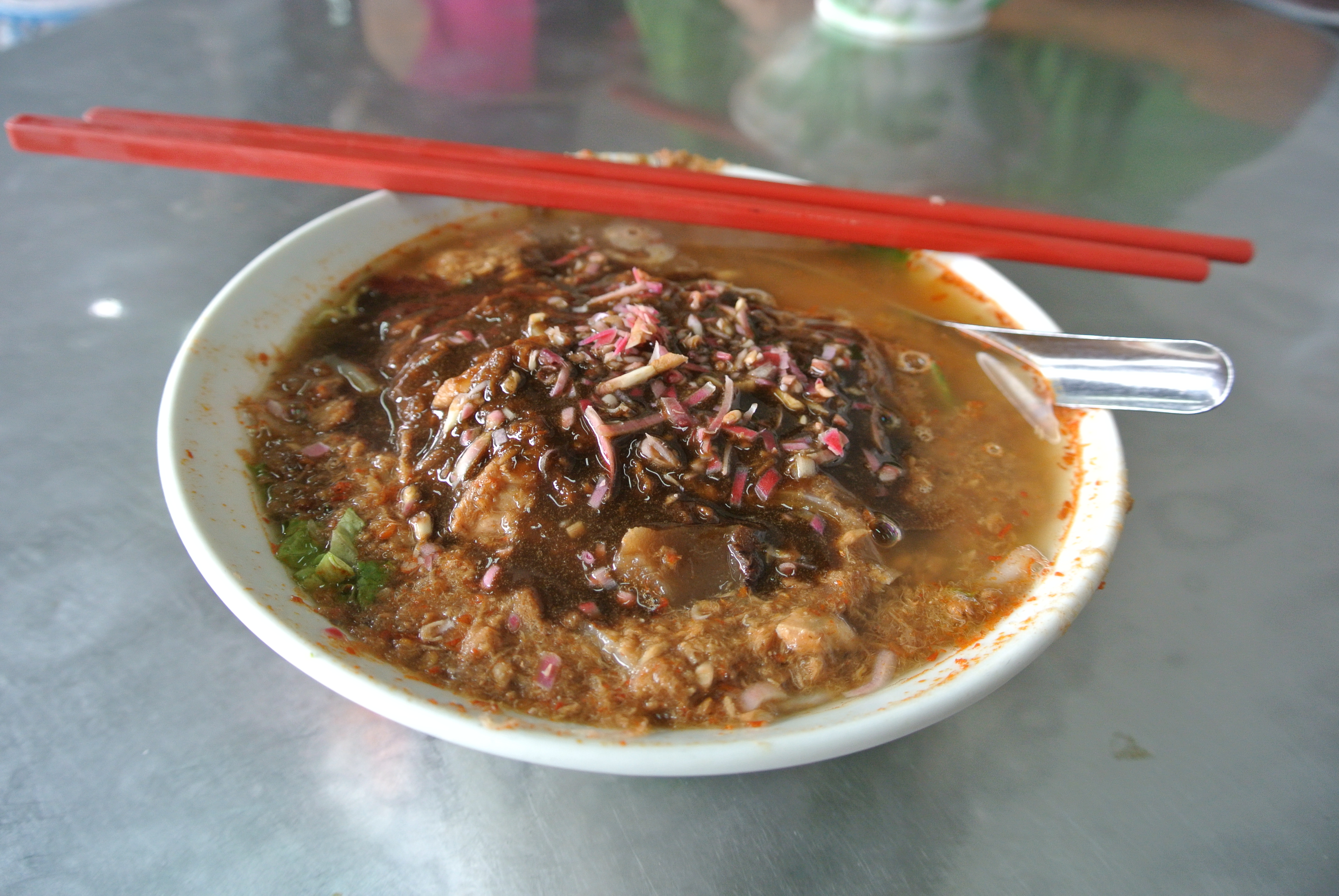 Bowl of Air Itam asam laksa with mint and onion