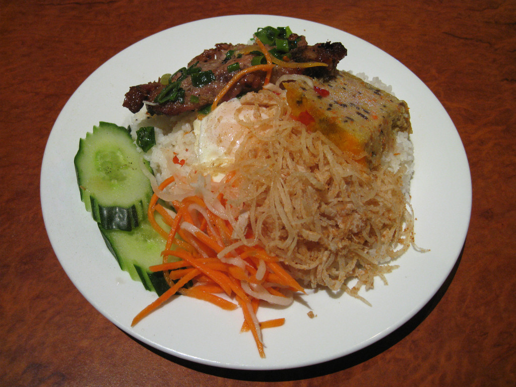 Plate of Vietnamese com tam broken rice with grilled pork