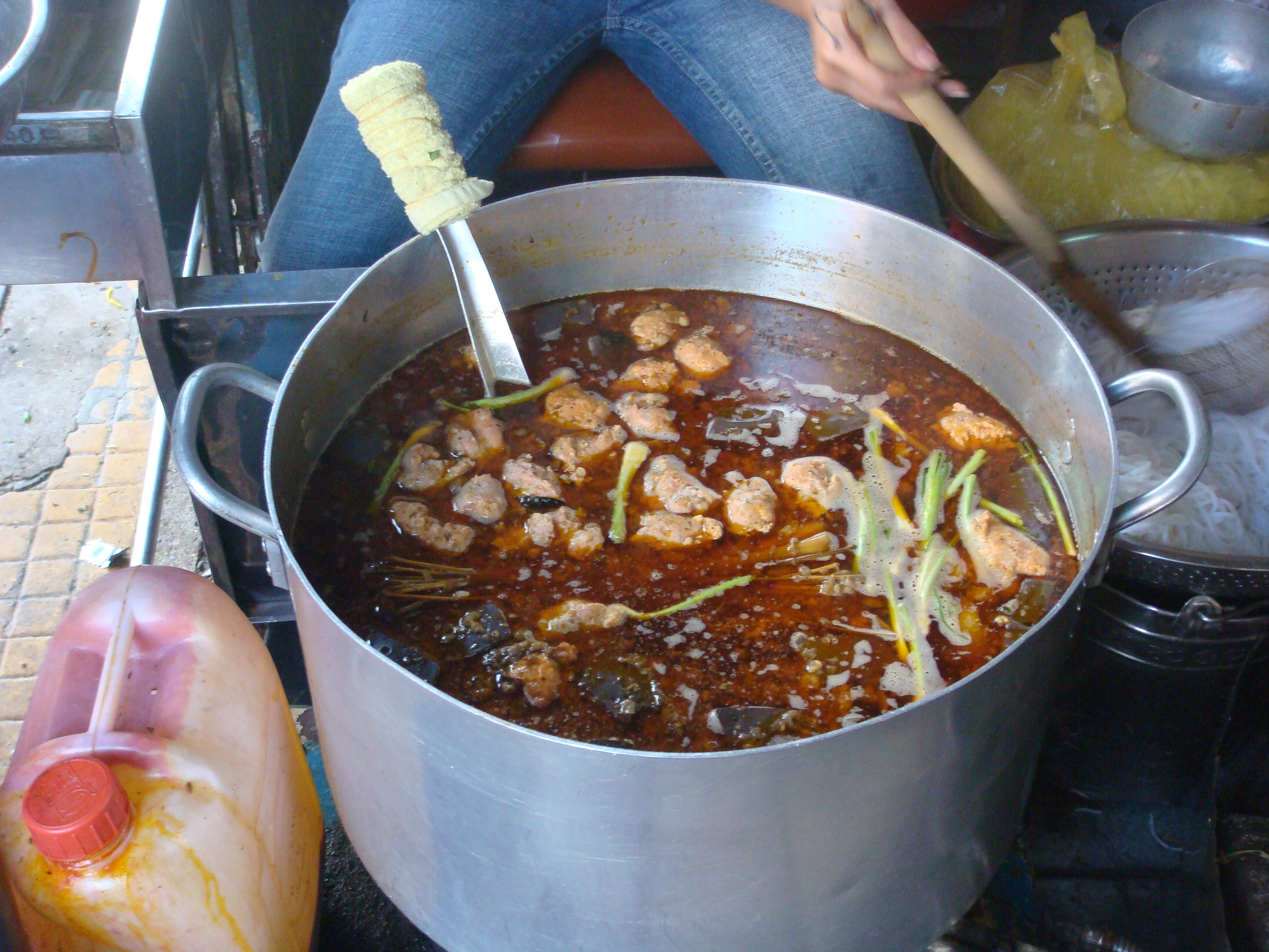 Pot of red-broth bun bo Hue noodle soup